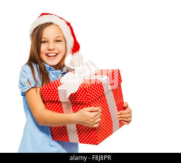 Happy girl faire cadeau de Noël in Santa hat Banque D'Images