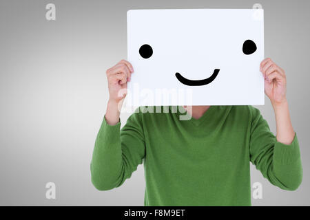 Image composite de man holding blank sign in front of face Banque D'Images