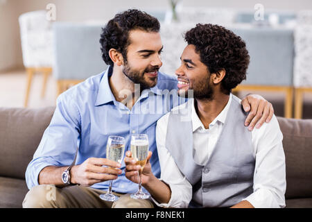 Happy gay couple drinking champagne Banque D'Images