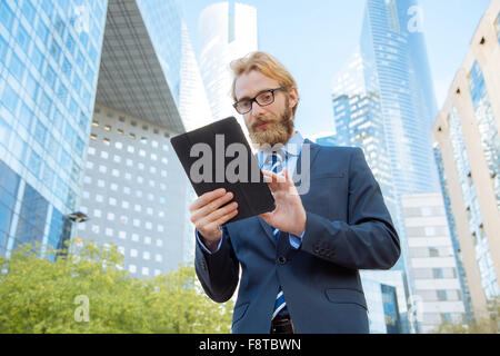 Businessman using a digital tablet in financial district Banque D'Images