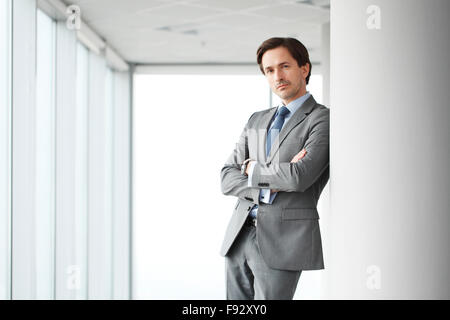 Portrait of handsome businessman in office windows Banque D'Images