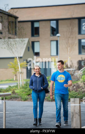 Freshers Semaine à l'Université UK : deux étudiants, homme et femme, marchant ensemble dans Penglais Farm des résidences, des blocs de nouveau un hébergement indépendant au début de Freshers semaine en université d'Aberystwyth, le 21 septembre 2015 Banque D'Images