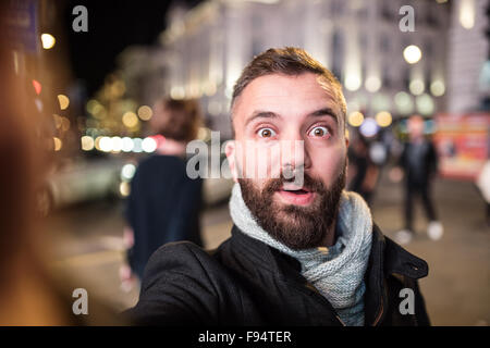Young handsome man with coffee cup in London city Banque D'Images