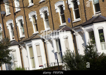 Hammersmith, Londres. Vue en angle de la rangée de maisons dans une rue résidentielle à Hammersmith. Bay Windows. Brique utilisée sur la moitié supérieure de la maisons. Banque D'Images