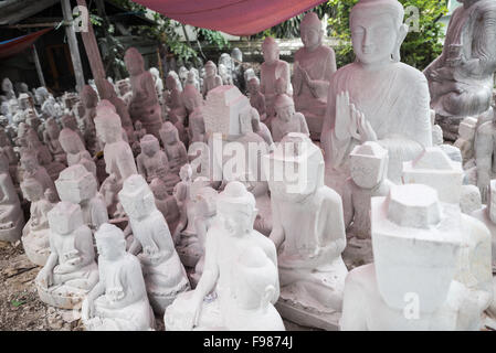 MANDALAY, Myanmar — les artisans locaux entreprennent le travail poussiéreux et épouvantable de sculpter des statues du Bouddha en marbre. Le bouddhisme étant la religion dominante au Myanmar, il y a une demande considérable pour les statues, avec des clients capables de choisir parmi une myriade de poses, tailles et styles. Les artisans sont regroupés dans une rue du quartier Chanmyathazi de Mandalay, près de la pagode Mahamuni. Banque D'Images