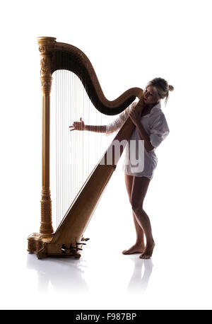 Silhouette de femme jouant de la harpe, isolé sur fond blanc Banque D'Images