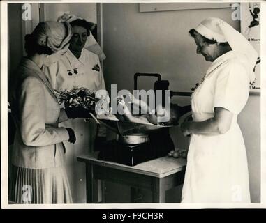 1964 - Royal Tour : la Reine a passé quelque temps à l'hôpital Karitane à Anderson's Bay, Dunedin, pendant les dernières étapes de la Royal Tour de Nouvelle-Zélande, et a vu de première main le système Plunket pour les soins des nourrissons et des jeunes enfants. Cette photo montre la reine souriant aux cabrioles d'un bébé de 15 semaines qui agrippe un oeillet rose dans le bouquet de sa Majesté. © Keystone Pictures USA/ZUMAPRESS.com/Alamy Live News Banque D'Images