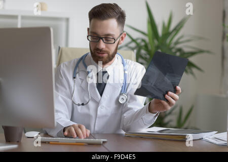 Médecin examinant un coude x-ray. La médecine et les soins de santé Banque D'Images