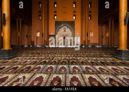 Une rangée de musulmans priant, s'inclinant de toucher la tête-de-chaussée face à un mur dans la salle de prière dans la Grande Mosquée, la Jama Masjid Banque D'Images