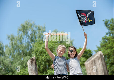 Deux jeunes filles jouant sur bateau de pirate en terrain d'aventure, Bavière, Allemagne Banque D'Images