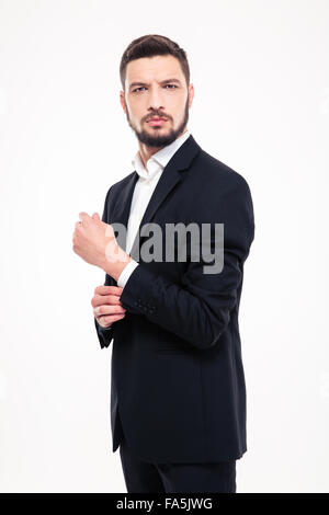 Portrait of a serious businessman standing isolé sur fond blanc Banque D'Images