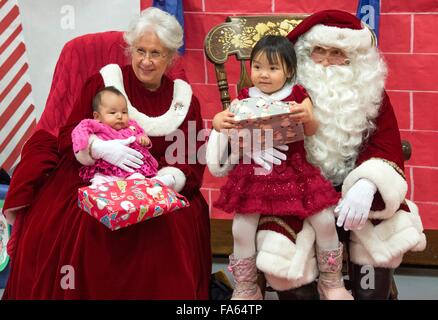 Le Père Noël et Mme Noël Alaska Native accueillent les enfants lors d'une visite dans les villages éloignés dans le cadre de l'Opération Père Noël 5 décembre 2015 à Saint Mary's, de l'Alaska. Le programme a été organisé pour 59 ans et apporte de Noël aux groupes mal desservis, les villages éloignés à travers l'Alaska. Banque D'Images