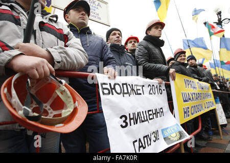 Kiev, Ukraine. Dec 23, 2015. Les mineurs ukrainiens est titulaire d'un des placards de la lecture de '' ne donnent pas de détruire l'industrie'', ''Le Budget de 2016 - la destruction de l'industrie'', ''pas de fermeture de la mines !'' et etc., au cours de leur manifestation devant la Verkhovna Rada (Parlement ukrainien) à Kiev, Ukraine, le 23 décembre, 2015. La demande de soutien de l'état de mineurs de l'industrie du charbon. Crédit : Serg Glovny/ZUMA/Alamy Fil Live News Banque D'Images