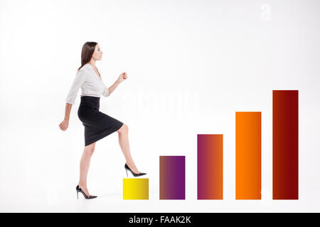 Young businesswoman walking up on stairs Banque D'Images