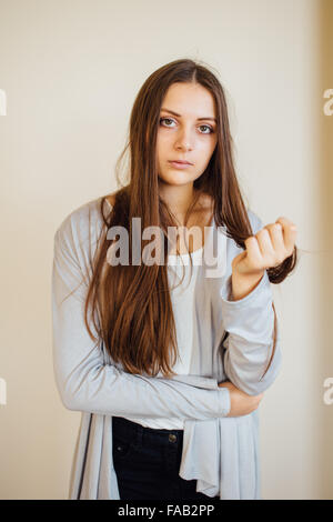 Lonely Girl sitting behind Christmas Tree with presents Banque D'Images