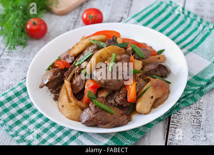 Foie de poulet rôti avec des légumes sur fond de bois Banque D'Images