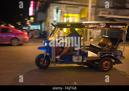 Tuk Tuk driver lire le journal. Tuk-tuks ou 'sam lor' (trois roues) utilisé pour être le favori de tous moyens de locomotion dans Banque D'Images