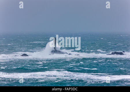 Vagues se brisant sur le phare de Drakkars. Lands End, Cornwall, UK. Des vents forts, des rafales de l'HPM 60, 2 janvier 2016. Credit : Barry Bateman / Alamy Live News Banque D'Images