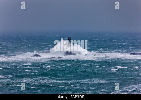 Vagues se brisant sur le phare de Drakkars. Lands End, Cornwall, UK. Des vents forts, des rafales de l'HPM 60, 2 janvier 2016. Credit : Barry Bateman / Alamy Live News Banque D'Images