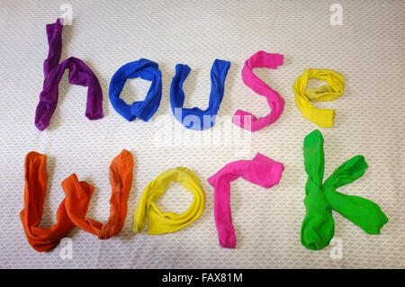 Les mots travail maison faite de chaussettes colorées portant sur une couette. Banque D'Images