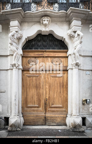 L'entrée en pierre blanc ancien en bois et portail à statues que soutenir les colonnes. Banque D'Images