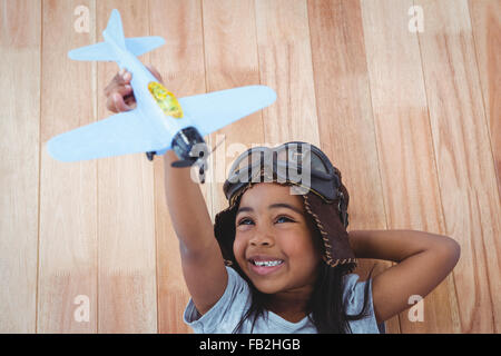 Smiling girl Playing with toy airplane Banque D'Images