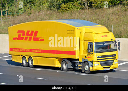 Vue latérale et avant carrosserie profilée hgv Deutsche Post DHL camion et chauffeur avec logo sur la remorque conduisant l'autoroute Angleterre Royaume-Uni Banque D'Images