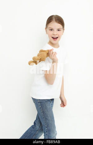 Teen girl holding a toy bear Banque D'Images