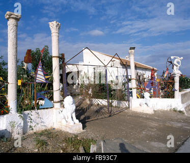 Piliers classiques et portes en fer forgé peint à la nouveauté des objets trouvés utilisés comme l'escrime en face de villa Banque D'Images