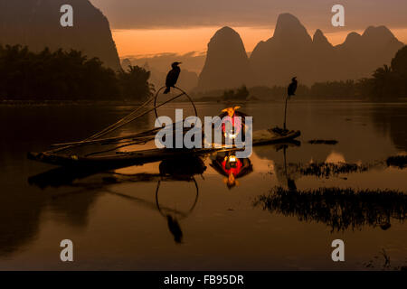 Rivière Li - Xingping, Chine. Aux environs de janvier 2016 - Un pêcheur s'apprête à aller à la pêche de nuit. Banque D'Images