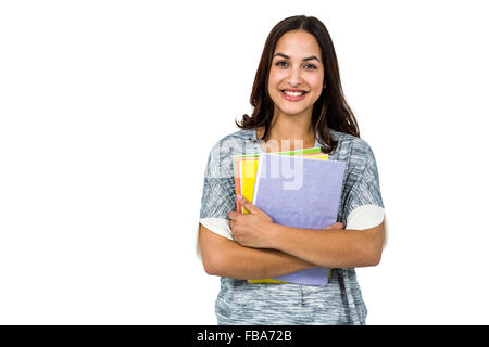 Portrait of smiling woman holding books Banque D'Images