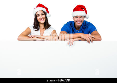 L'homme et la femme wearing Santa hat Banque D'Images