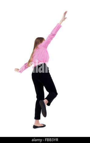 Jeune femme d'affaires. L'équilibrage ou dodge tomber femme. Vue arrière Vue arrière. collection les gens de personne. Plus isolé sur fond blanc. L'employé de bureau de fille en pantalon noir au moment de l'automne. Banque D'Images