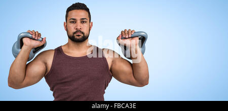 Image composite de l'homme graves musculaire kettlebells de levage Banque D'Images