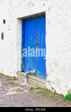 Une porte en bois bleu en bâtiment en pierre blanchis en Ecosse Banque D'Images