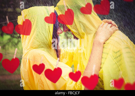 Image composite du couple hugging in the rain Banque D'Images