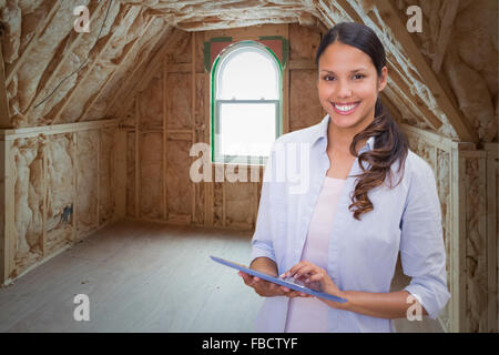 Composite image of woman using tablet pc Banque D'Images