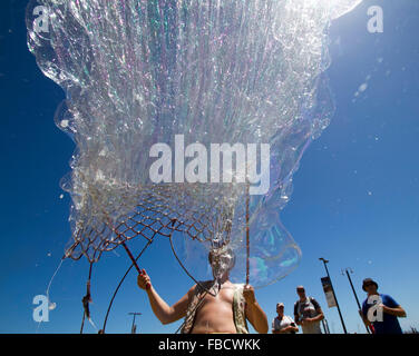 Adelaide en Australie. 15 janvier 2016. Un homme crée un superbe écran de bulles de savon en été dans la région de Adelaide Glenelg Crédit : amer ghazzal/Alamy Live News Banque D'Images