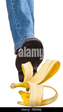 Jambe droite mâle en jeans et Brown Shoe marcher sur peau de banane isolé sur fond blanc Banque D'Images