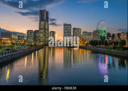 La réflexion de Yokohama Landmark Tower et les immeubles de bureaux modernes sur l'eau au crépuscule Banque D'Images