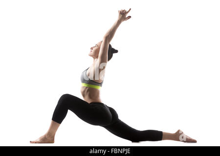 Portrait of happy sporty belle jeune brunette woman in sportswear travailler, agir sur une jambe faible, Anjaneyasana poser Banque D'Images