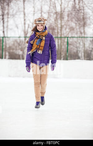 Jeune femme patinage sur glace avec des patins Banque D'Images