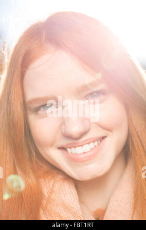 Closeup portrait of a smiling redhead woman looking at acamera Banque D'Images