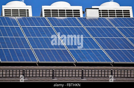 Des panneaux solaires et l'air condiitioners sur le toit d'un bâtiment Banque D'Images