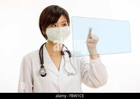 Chinese female doctor with stethoscope en appuyant sur le bouton virtuel sur l'interface avec le doigt Banque D'Images