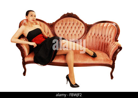 Asian girl sitting on sofa. Banque D'Images