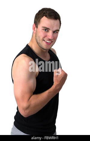 Young attractive man flexing biceps sa Banque D'Images