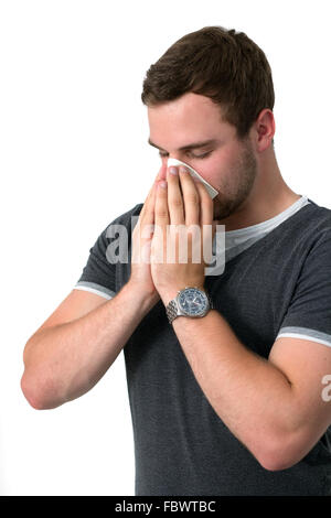 Young Man Blowing Nose Banque D'Images