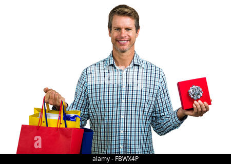 Happy man holding shopping bags and gift box Banque D'Images