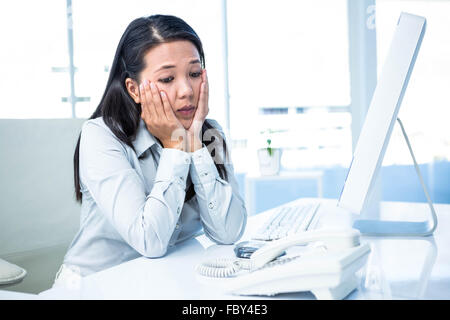 Of Asian businesswoman with hands on face Banque D'Images